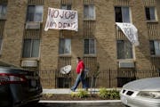 Signs that read "No Job No Rent" hang from the windows of an apartment building during the coronavirus pandemic in Washington, D.C. Landlords across M