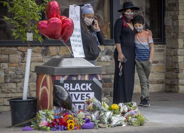 "It's devastating," said Zola Richardson as she held her son Gabriel 11, close as she stood to pay respect near the site where a middle-aged black man
