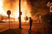 Minneapolis residents used garden hoses and buckets to save homes May 27 after rioters set fire to a housing complex under construction near the Third