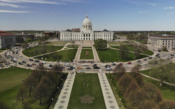 Vehicles circled the Minnesota State Capitol, covered with flags and signs, during a May 2 protest against Gov. Tim Walz’s “Stay Home MN” execut