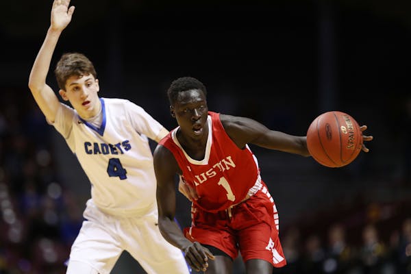 Austin's Both Gach (right, playing in the Class 3A basketball tournament in 2017) will announce his decision on where he will play his junior season o
