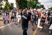 John Thompson, activist and candidate for Minnesota state representative, marched outside St. Anthony Village City Hall for Philando Castile in July.