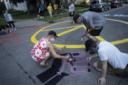 Anne Thompson helped paint a mural on a street intersection in the Longfellow neighborhood. Her block’s residents voted Thursday to end patrols and 