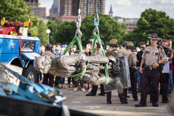 A tow truck removed a statue of Christopher Columbus after it was toppled at the Minnesota State Capitol on June 10.