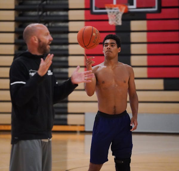 Tamin Lipsey spun a ball on his finger while listening to coach Jay Fuhrmann during a D1 Minnesota practice.