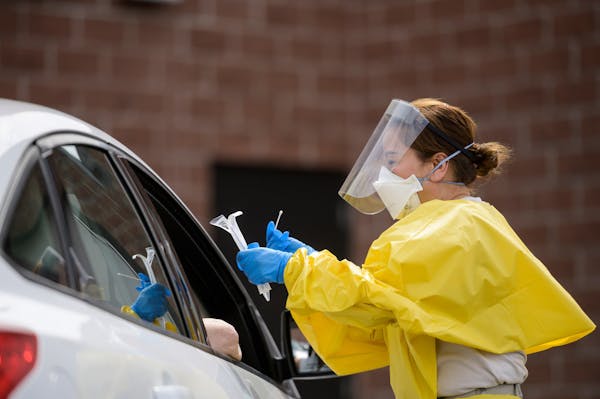 A free COVID-19 test was administered to a passenger at the drive-up testing site behind the Minneapolis Armory in May. [Credit: Aaron Lavinsky/Star T