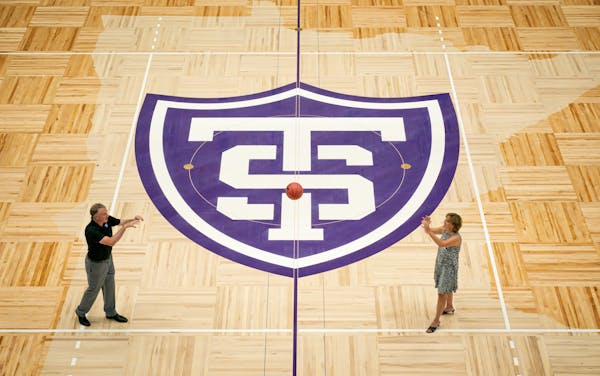 St Thomas men's basketball coach John Tauer and women's coach Ruth Sinn stepped out for the first time onto the newly unveiled basketball court.