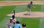 Minnesota Twins starting pitcher Kenta Maeda, top, of Japan, throws against the Chicago White Sox during the first inning of a baseball game in Chicag