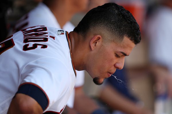 Twins starter Jose Berrios spit out some water in the dugout during a 2018 game. MLB has put on ban on spitting this season to try to curb the spread 