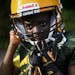 Damarius Miller, 10, adjusted his helmet before running a drill at Wednesday's practice. "I was afraid to get shot," said Miller of the recent shootin