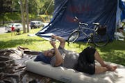 Jon, who declined to give his last name, watched a YouTube video on his phone to pass the time Wednesday afternoon in the encampment at Lyndale Farmst