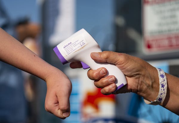 All fairgoers at Head of the Lakes Fair in Superior, Wis., on Friday got a wrist temperature check before entering the fairground.