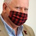 Gov. Tim Walz wore a buffalo plaid cloth mask during questions at Wednesday's news conference announcing a statewide mask mandate to help slow the spr