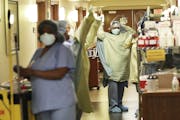 Health care workers donned PPE at Bethesda Hospital in May in St. Paul.