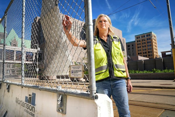 Deb Hilmerson, a veteran construction site safety consultant, with a barrier fence system she developed that is being used in Minneapolis. The system 