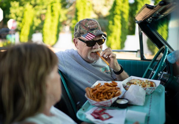 Ralph Stinger bit into his first French fry while dining in his ’64 Ford Galaxie 500 with his wife, Bobbi, at Clays Galaxy Drive In.