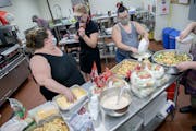 Jennifer Lancour, left, worked with volunteers making meals at First Congregational Church. Homegrown mutual aid groups are popping up all over.