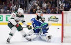 Minnesota Wild's Alex Galchenyuk, left, scores against Vancouver Canucks goalie Jacob Markstrom, of Sweden, during a shootout in February.