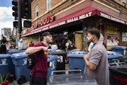 Cup Foods worker Billy Abumayyaleh, right, brother to owner Mahmoud Abumayyaleh, was confronted by an activist on Monday, Aug. 3. He was trying to cle