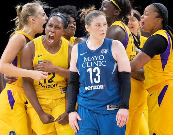Lindsay Whalen tried to distance herself from the L.A. scene as the Sparks’ Chelsea Gray (12) celebrated her game-winning shot with teammates.
