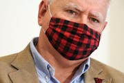Gov. Tim Walz wore his buffalo plaid cloth mask during a press conference announcing a statewide mask mandate to help slow the spread of COVID-19 in J