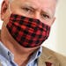 Gov. Tim Walz wore his buffalo plaid cloth mask during questions at a press conference to announce a statewide mask mandate to help slow the spread of