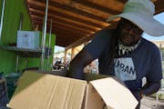 Gary Ross stocked vegetables at a free stand near the Midtown Greenway. Help is emerging for farmers that supply local markets.