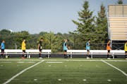 The East Ridge boys' soccer team stood for the national anthem while distanced 6 feet apart before a game against Mounds View on Thursday.