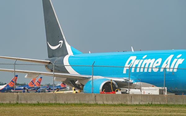 Workers unloaded a Prime Air jet after it landed at Minneapolis-St. Paul International Airport. Sun Country’s deal with Amazon is helping the airlin