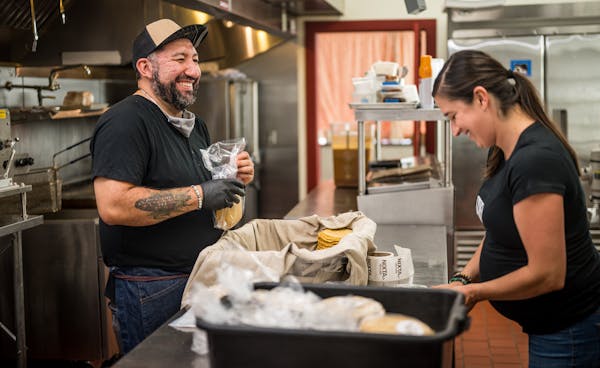 Chef Gustavo Romero in the kitchen of Nixta, with Kate Kiernoziak, his business partner and spouse.