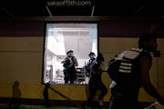 Police cleared out and secured Saks OFF 5th in downtown Minneapolis on Wednesday night after unrest that included looting and smashing of windows.
