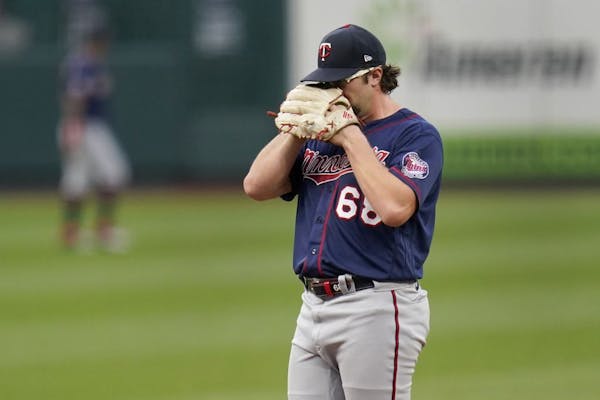 Minnesota Twins starting pitcher Randy Dobnak pauses on the mound before being removed during the third inning in the second game of a baseball double
