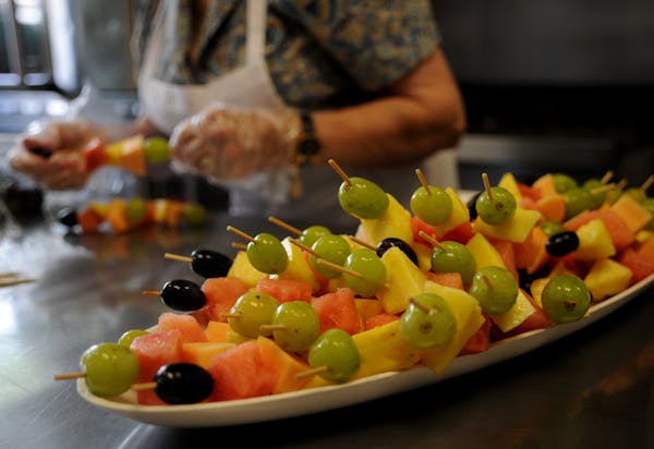 Caterers prepared some fruit skewers for a funeral meal.