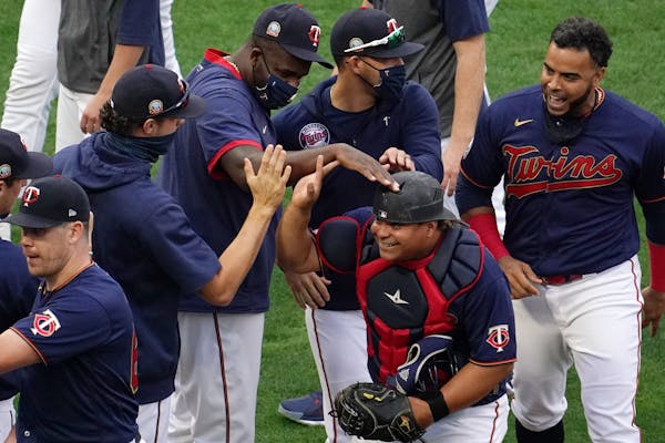 Twins catcher Willians Astudillo (64) was mobbed by his teammates at the end of the game. He earlier scored the game-winning run in the eighth inning.