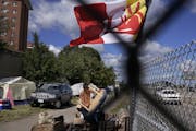 The American Indian Movement flag flew on the edge of a homeless encampment that has once again sprung up at the site of the Wall of Forgotten Natives