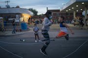 Marcia Howard jumped rope with Silas Yechout, 10, during a community dinner at the George Floyd memorial at 38th and Chicago in Minneapolis last month