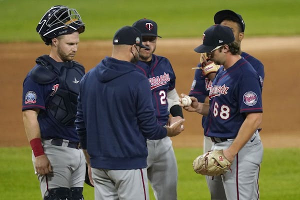 Minnesota Twins manager Rocco Baldelli, center, pulls Minnesota Twins starting pitcher Randy Dobnak (68) during the fifth inning of the team's basebal