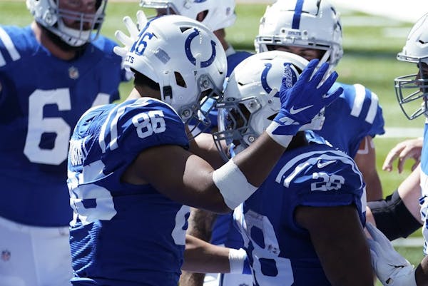Indianapolis Colts' Jonathan Taylor (28) celebrates with Noah Togiai (86) after running for a touchdown during the first half of an NFL football game 