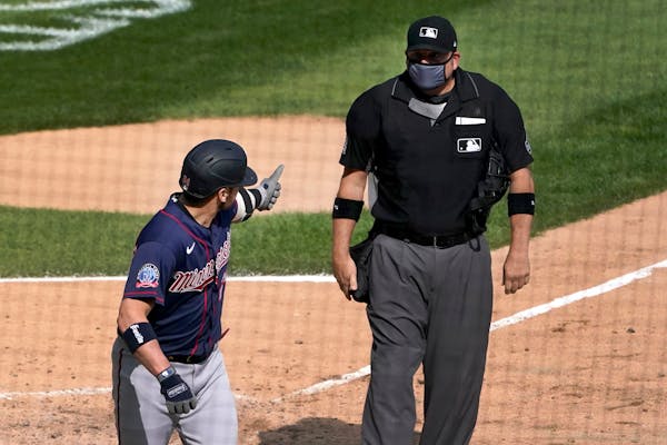 The Twins' Josh Donaldson gives home plate umpire Dan Bellino the thumbs up sign after Bellino ejected him from the game on Thursday.