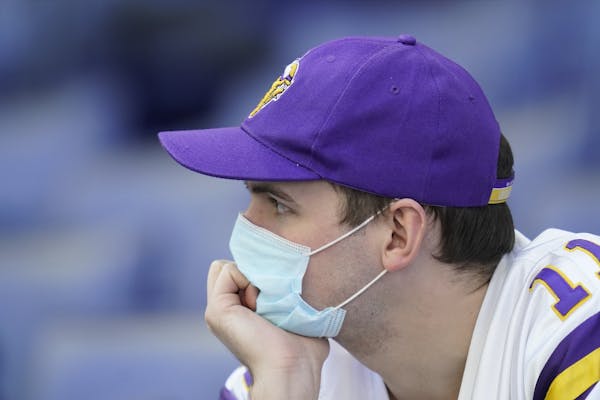 A Minnesota Vikings fan watches during the second half of an NFL football game between the Indianapolis Colts and the Minnesota Vikings, Sunday, Sept.
