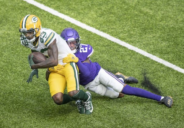 Vikings cornerback Cameron Dantzler tackling Packers wide receiver Marquez Valdes-Scantling during Sunday's season opener.