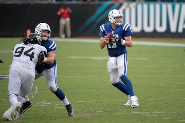 Colts quarterback Philip Rivers drops back to pass as offensive tackle Anthony Castonzo blocks against Jaguars defensive end Dawuane Smoot