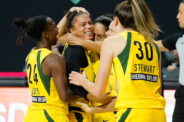 Seattle forward Alysha Clark celebrated her buzzer-beating putback with guard Jewell Loyd (24) and forward Breanna Stewart (30) following the Storm's 
