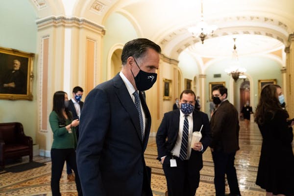 Sen. Mitt Romney (R-Utah), wearing a face mask, leaves the Senate chambers after a vote at the Capitol Building in Washington, on Tuesday, Sept. 22, 2