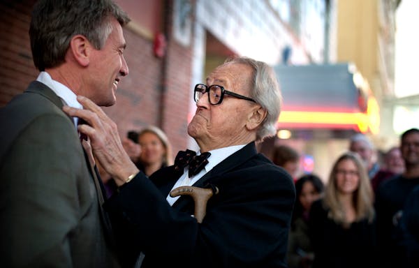 Dudley Riggs, founder of Brave New Workshop, helped Mayor R.T. Rybak put on a bow tie to match Dudley's signature bow tie in November 2011. The Theate