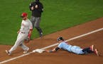 Minnesota Twins third baseman Ehire Adrianza (13) stole third base on a wild pitch by Cincinnati Reds pitcher Anthony DeSclafani (28) in the seventh i