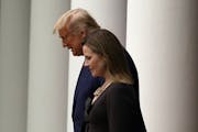 President Donald Trump walks with Judge Amy Coney Barrett to a news conference to announce Barrett as his nominee to the Supreme Court, in the Rose Ga