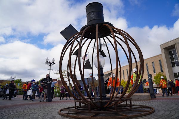 A centennial anniversary 14-foot sculpture was unveiled outside the City Hall of Anoka.