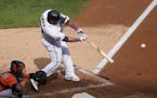 Minnesota Twins' Nelson Cruz hits an RBI double off Houston Astros pitcher Zack Greinke in the third inning of an American League wild-card series bas