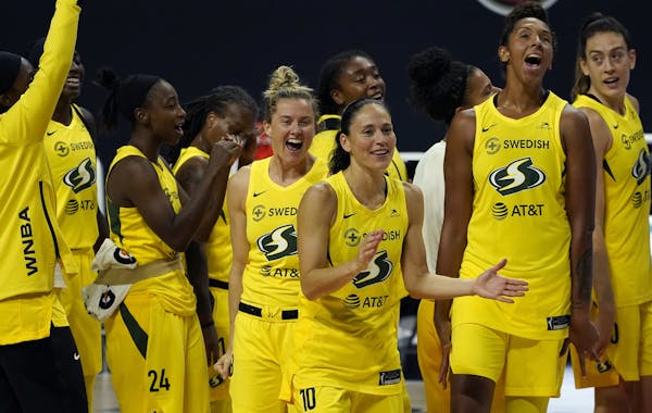 The Seattle Storm celebrate after the team defeated the Minnesota Lynx during Game 3 of a WNBA basketball semifinal round playoff series Sunday, Sept.